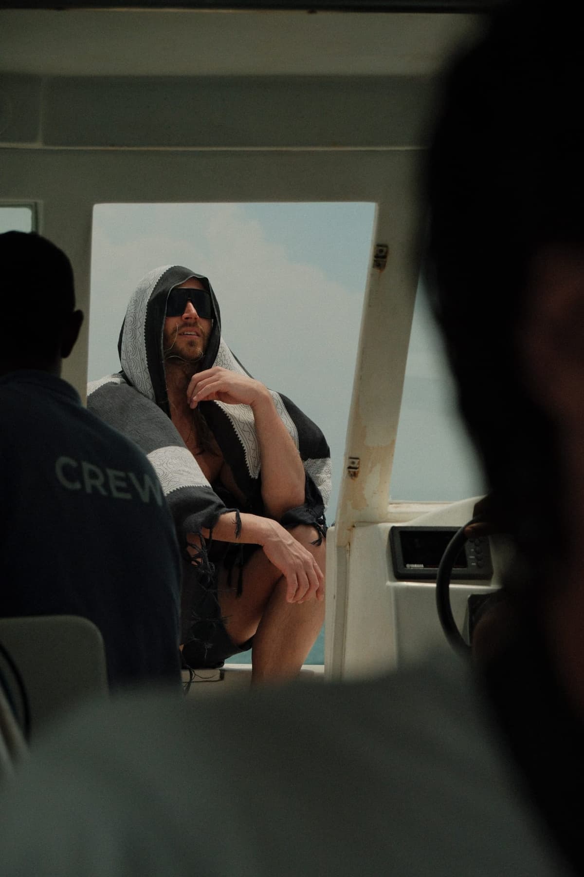 Towel-draped, sunglasses on, somewhere between sessions