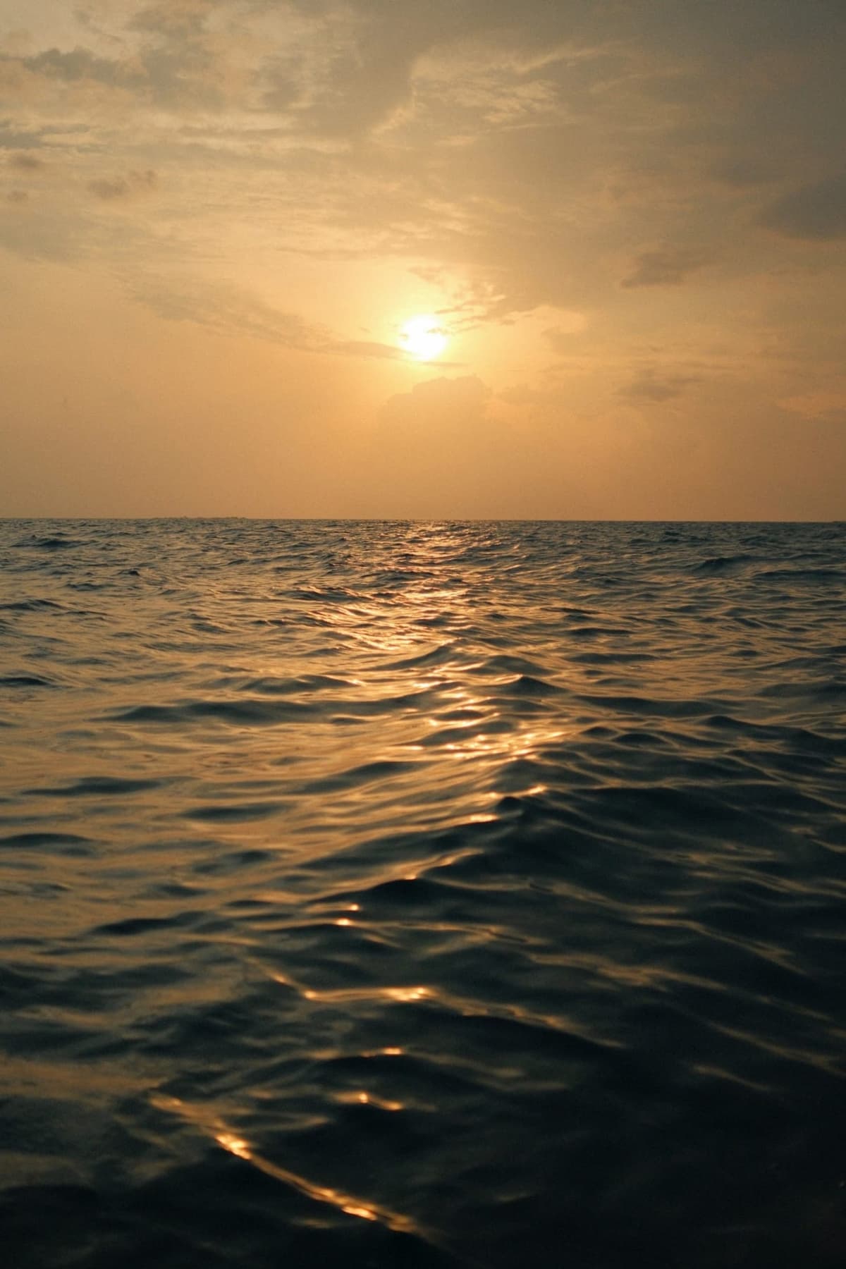 Golden road laid flat across an empty ocean