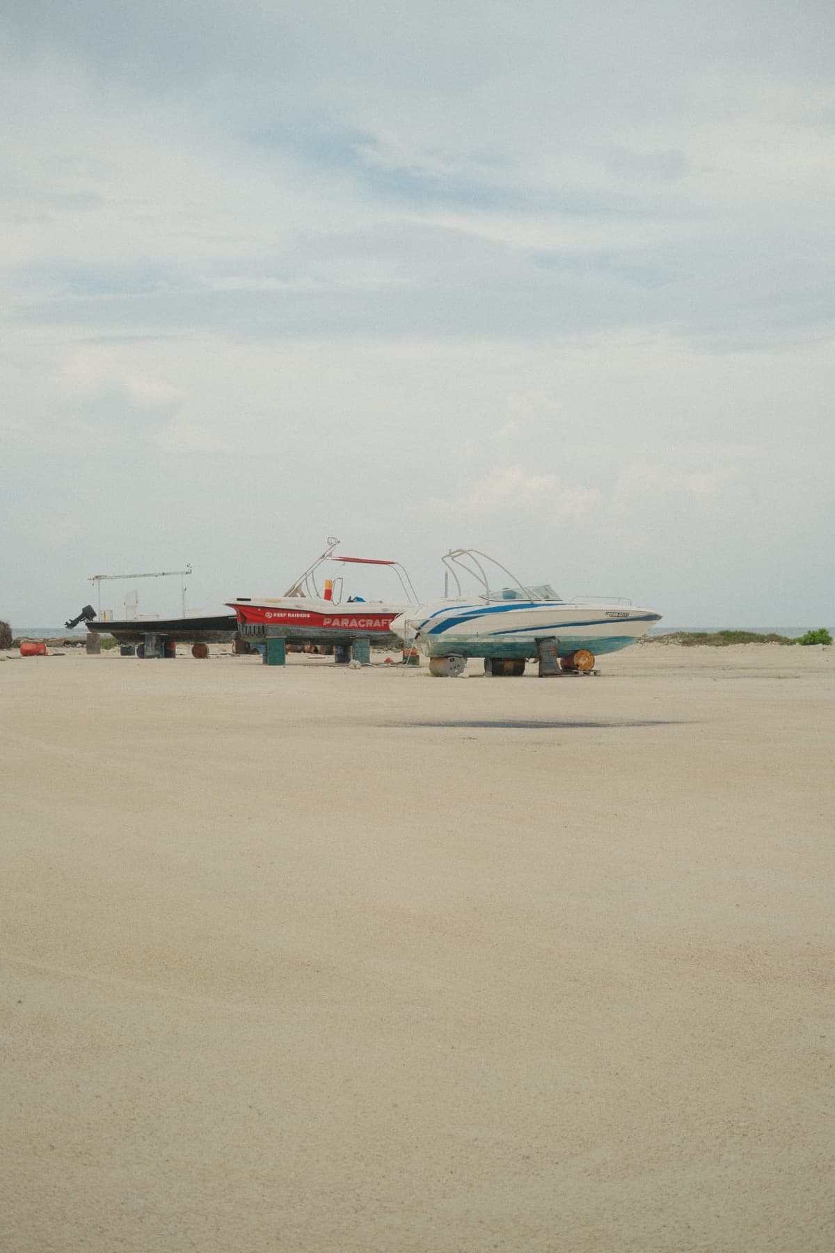 Two boats stranded on sand, waiting for the season