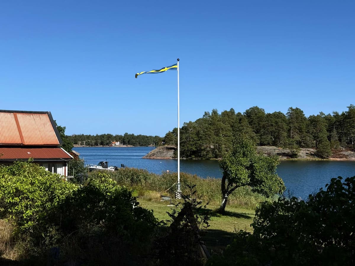 Orange tiles, a flagpole, and the water beyond the garden
